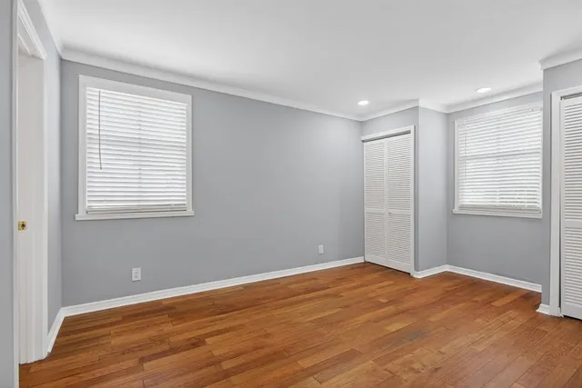 wooden floor in an empty room with a window