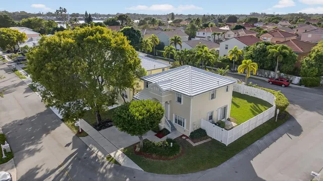 an aerial view of a house with a yard and lake view