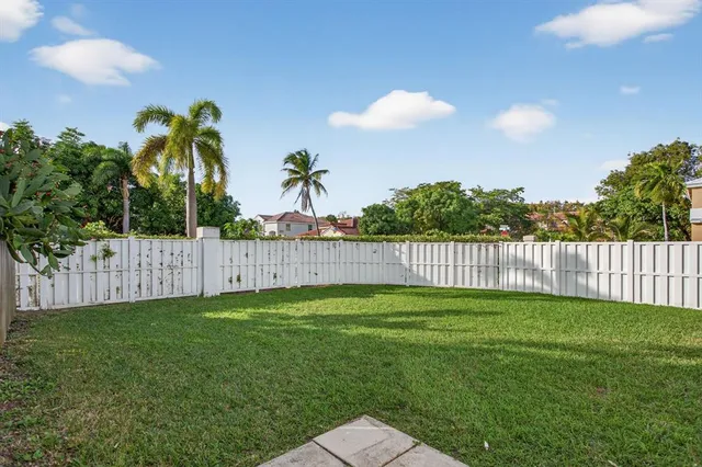 a view of a yard with a fence