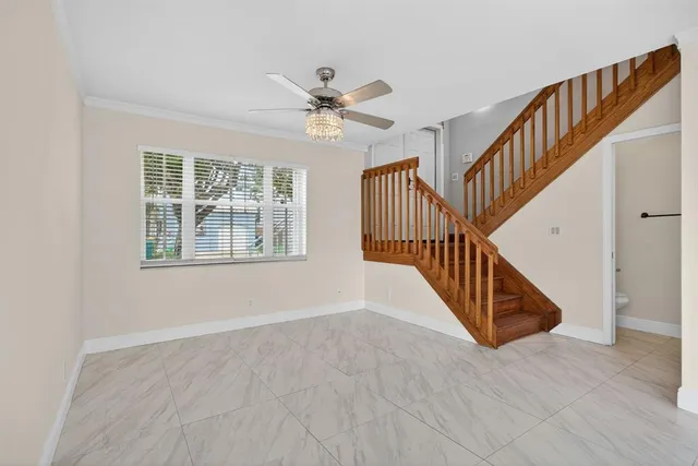 a view of staircase with white walls and windows