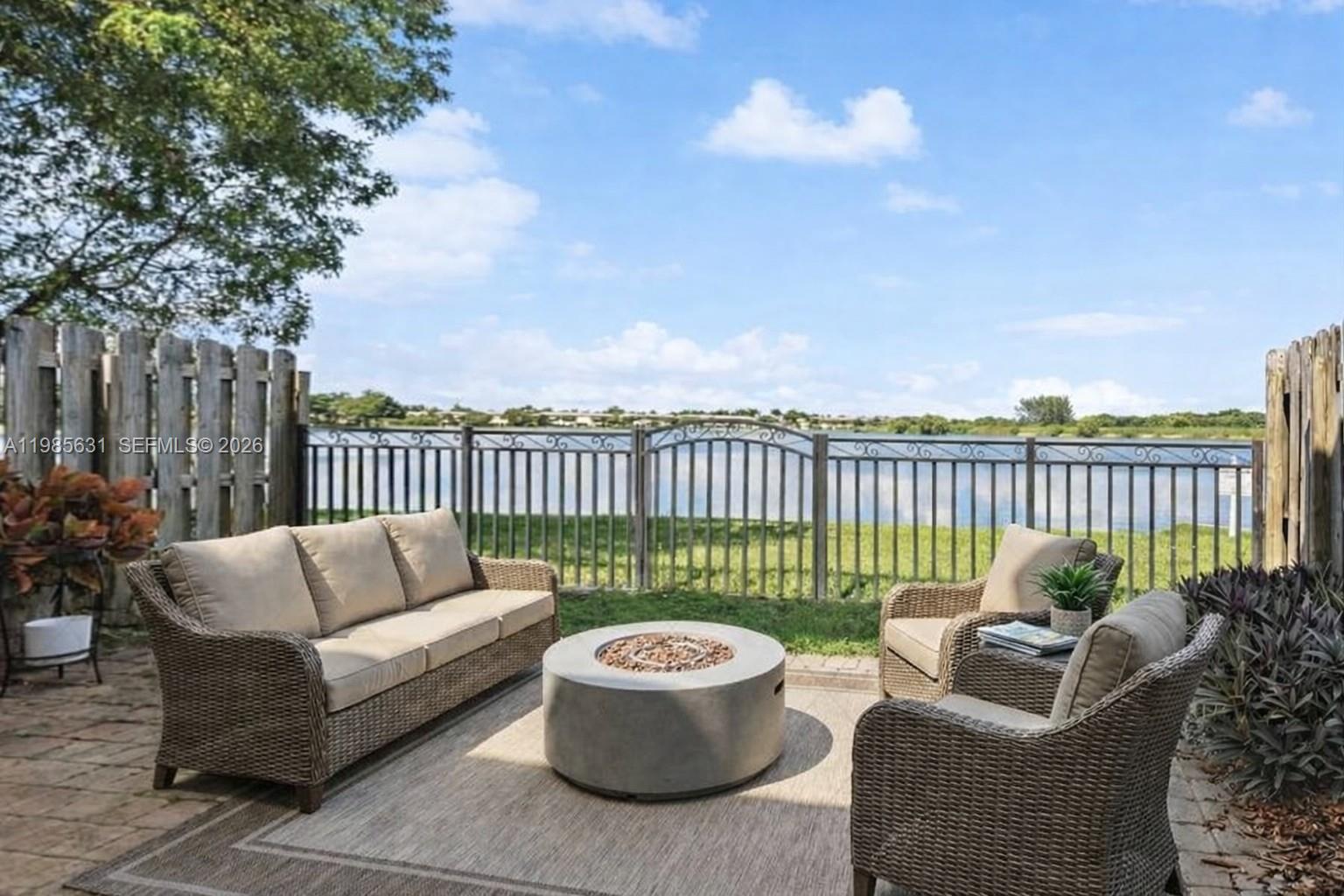 a roof deck with couches and potted plants