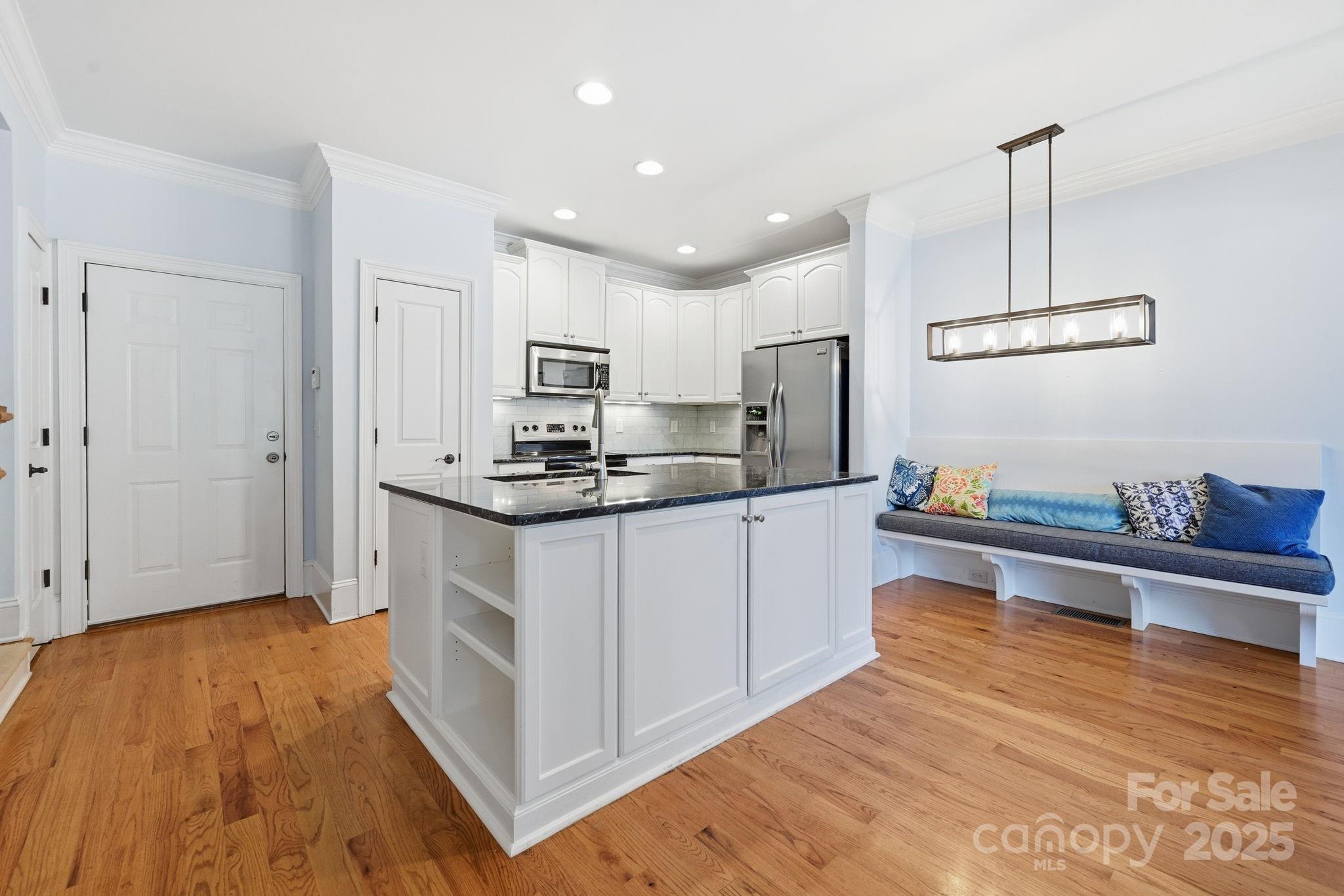 329 Spring Street Davidson, NC 28036 - Photo 11 of 31 a kitchen with kitchen island a sink stainless steel appliances and cabinets