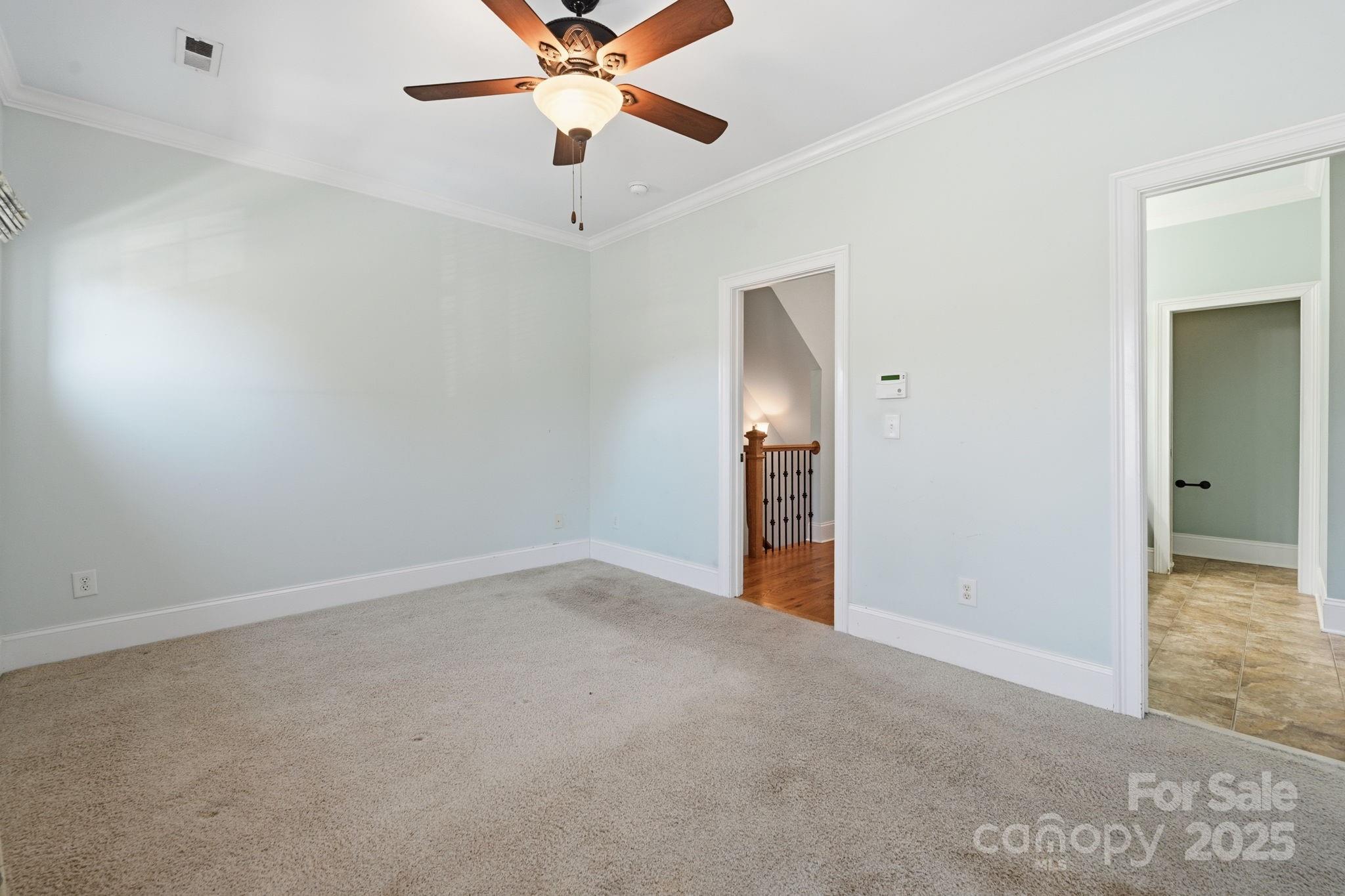 329 Spring Street Davidson, NC 28036 - Photo 14 of 31 an empty room with closet and a chandelier fan