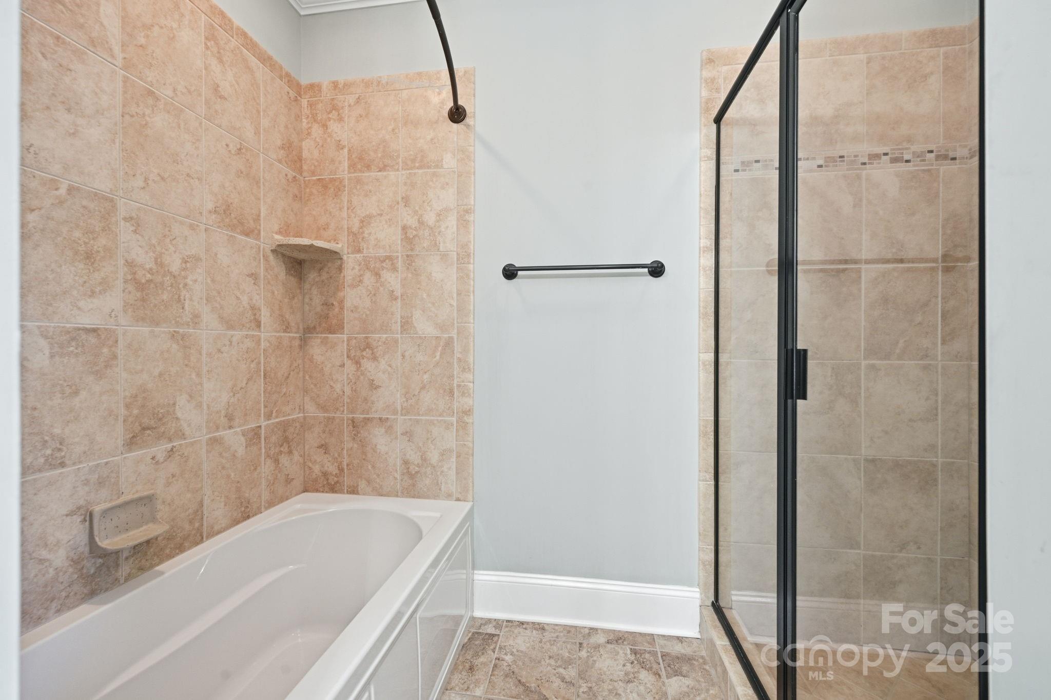 329 Spring Street Davidson, NC 28036 - Photo 15 of 31 a bathroom with a bathtub and shower