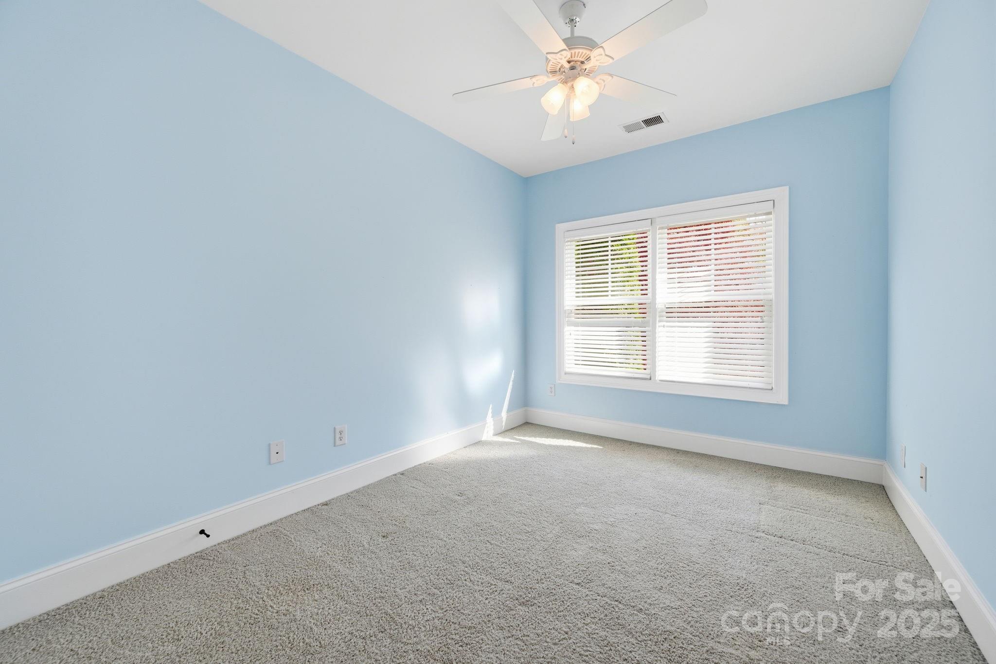329 Spring Street Davidson, NC 28036 - Photo 20 of 31 an empty room with a window and a fan