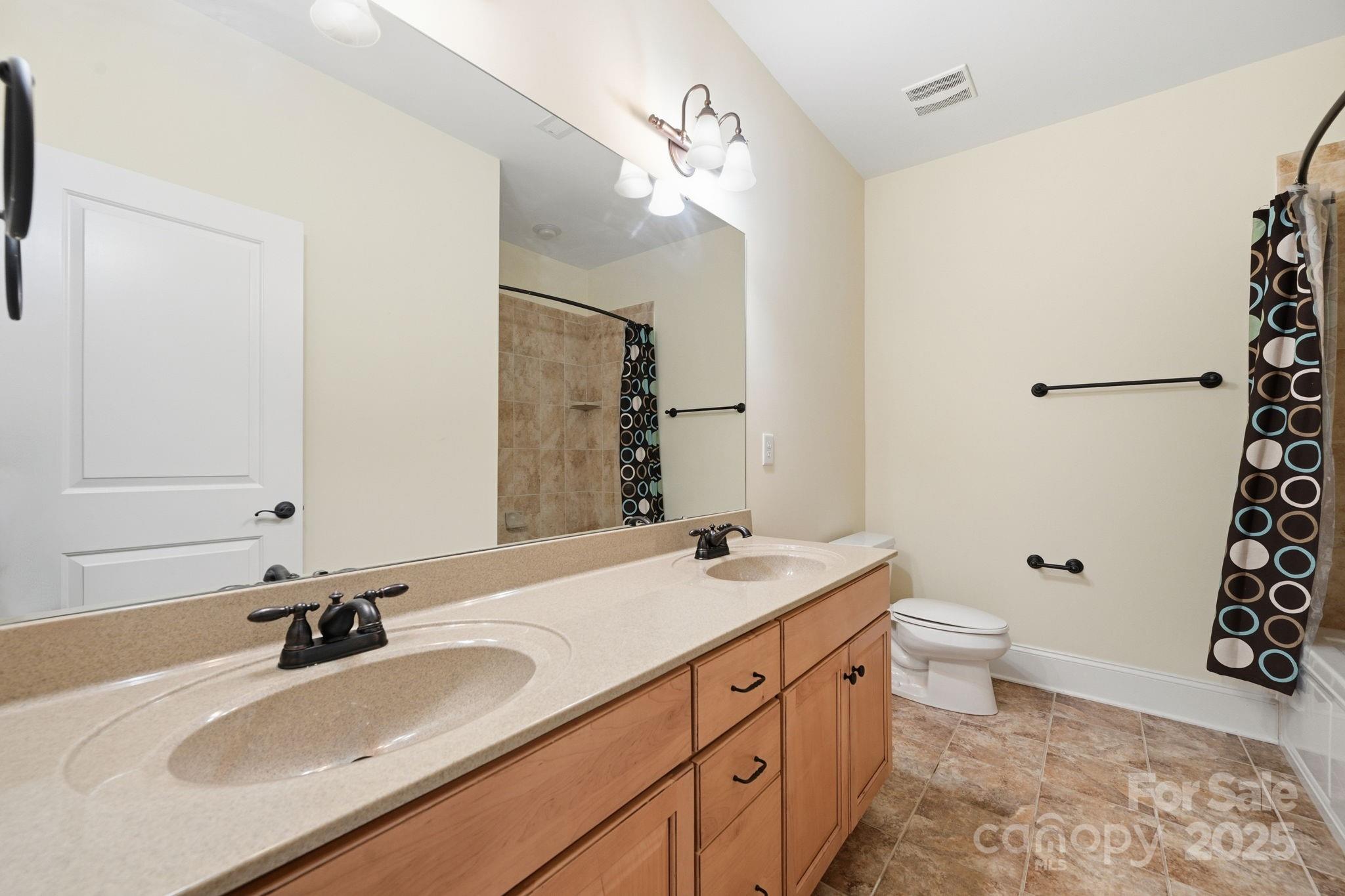 329 Spring Street Davidson, NC 28036 - Photo 23 of 31 a bathroom with a double vanity sink toilet and shower