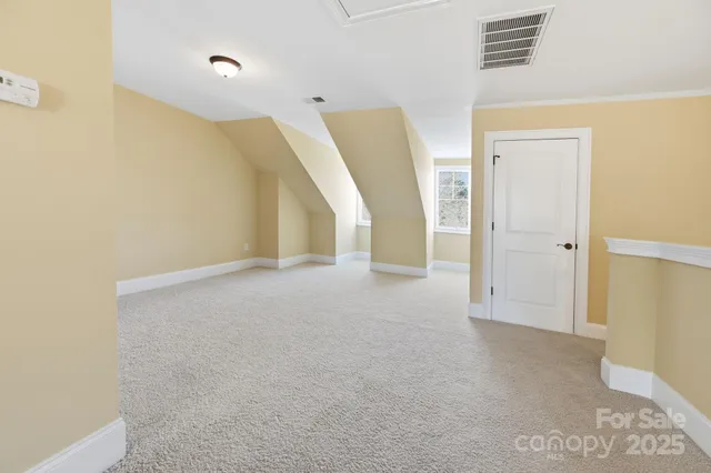 a view of a big room with closet and windows