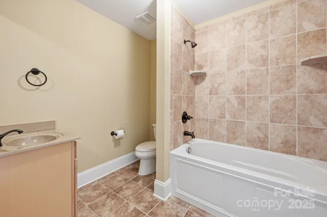 a view of a brick house with a yard and plants