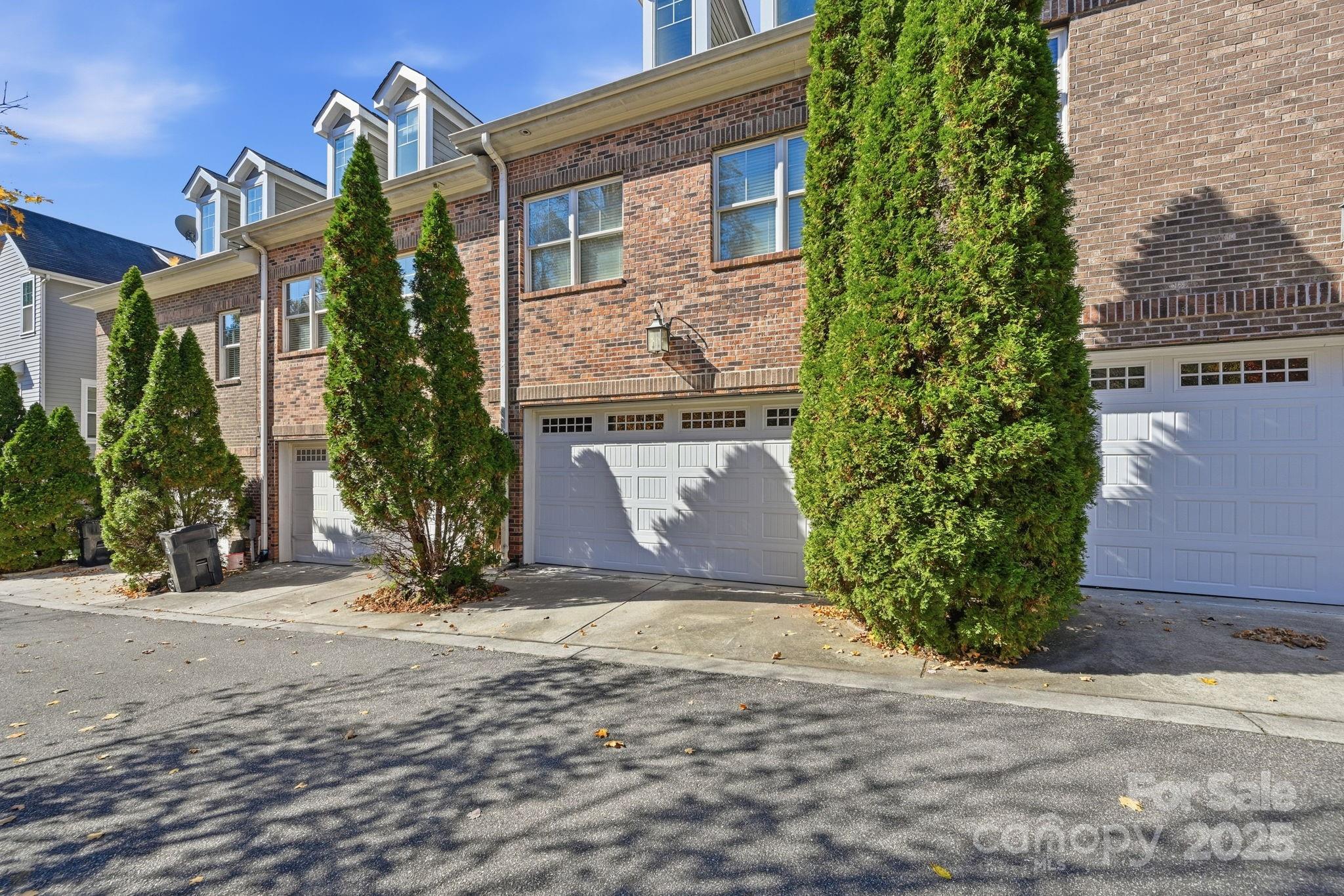 329 Spring Street Davidson, NC 28036 - Photo 28 of 31 a view of a brick house with a yard and plants