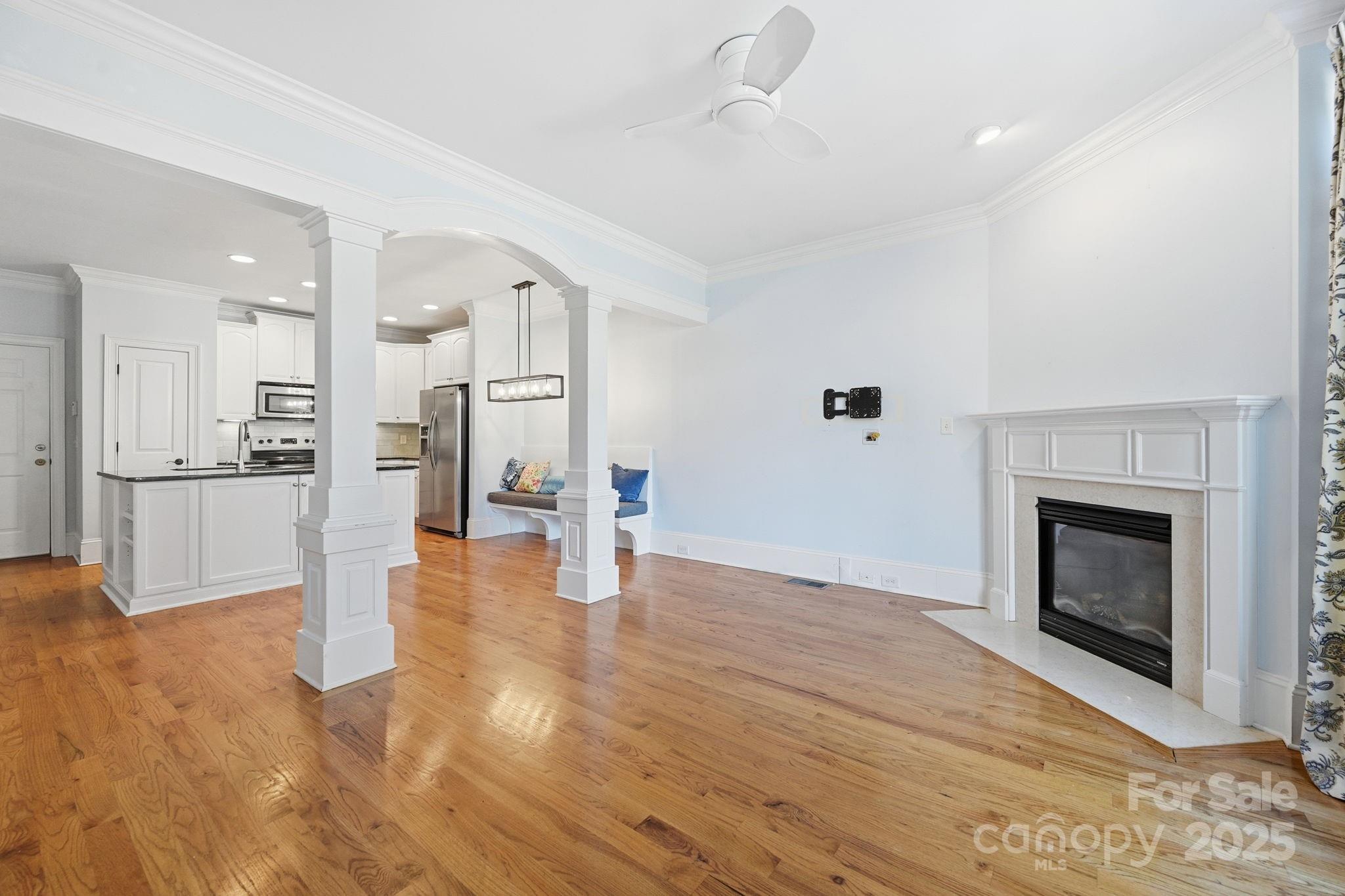329 Spring Street Davidson, NC 28036 - Photo 6 of 31 a view of a livingroom with wooden floor and a kitchen