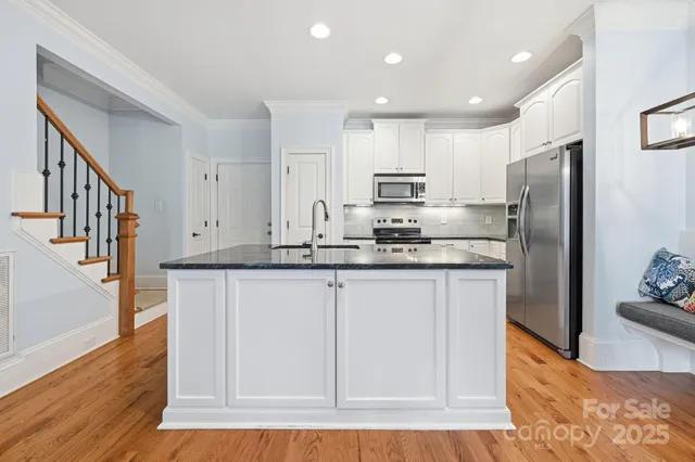 a kitchen with stainless steel appliances a sink stove and refrigerator