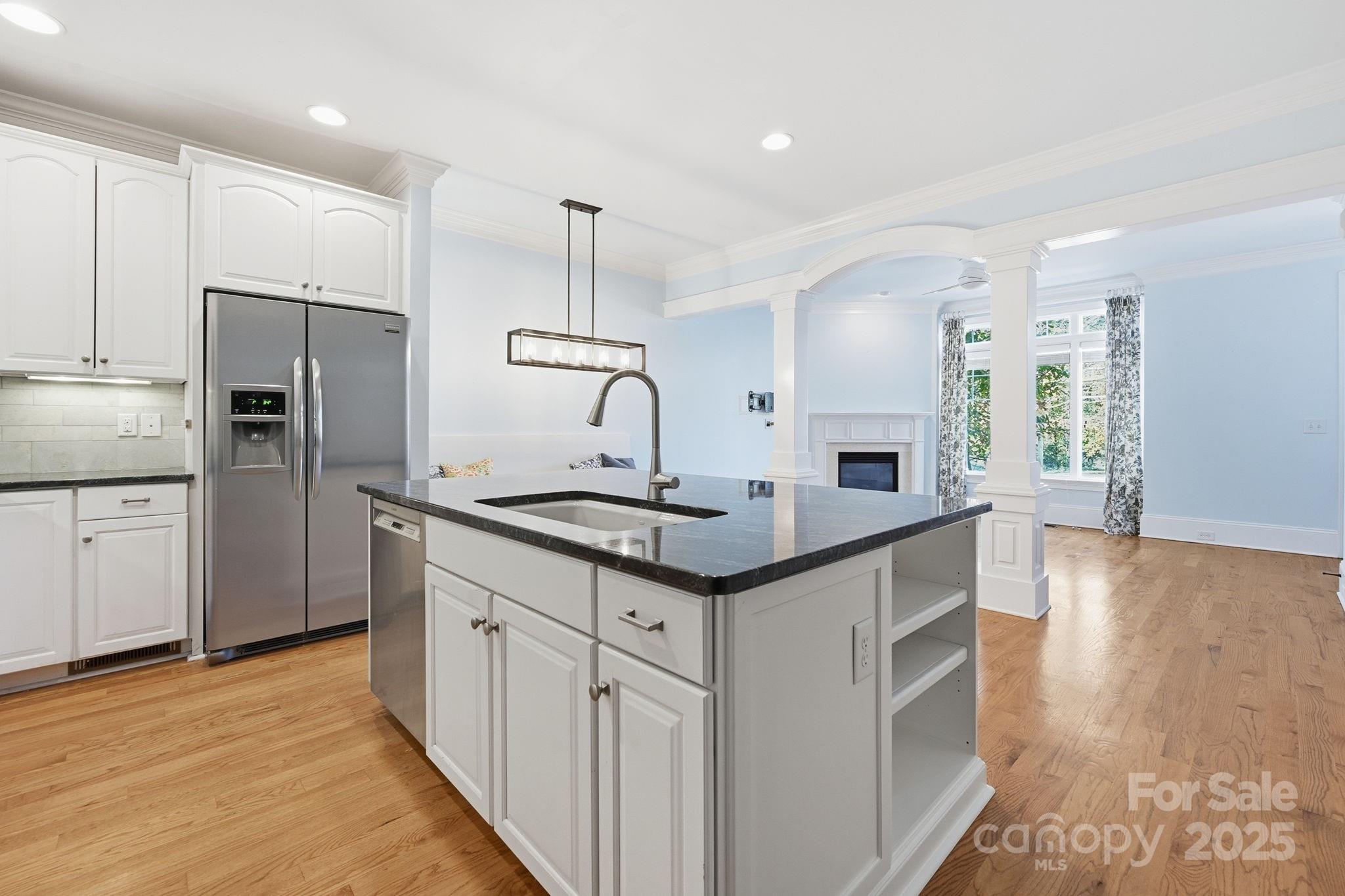 329 Spring Street Davidson, NC 28036 - Photo 8 of 31 a kitchen with stainless steel appliances a sink stove and refrigerator