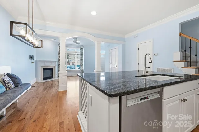 a kitchen with kitchen island a sink stainless steel appliances and cabinets