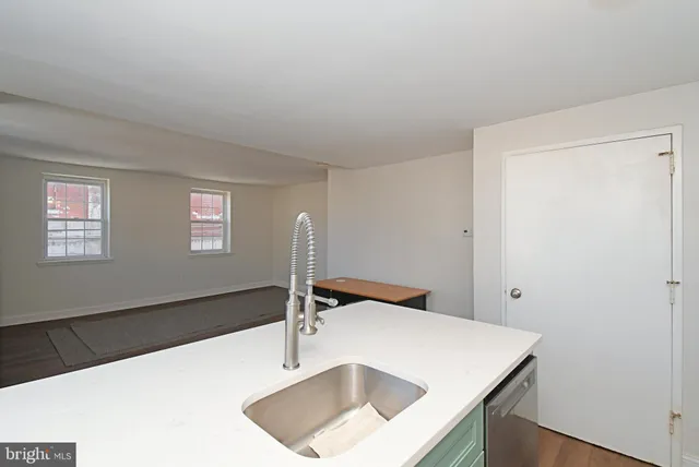 a kitchen with stainless steel appliances a sink a stove and a window