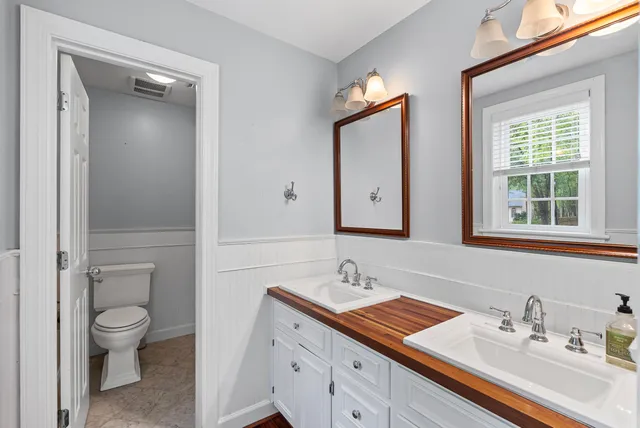 a bathroom with a toilet sink and mirror