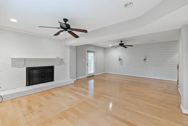 wooden floor in an empty room with a fireplace