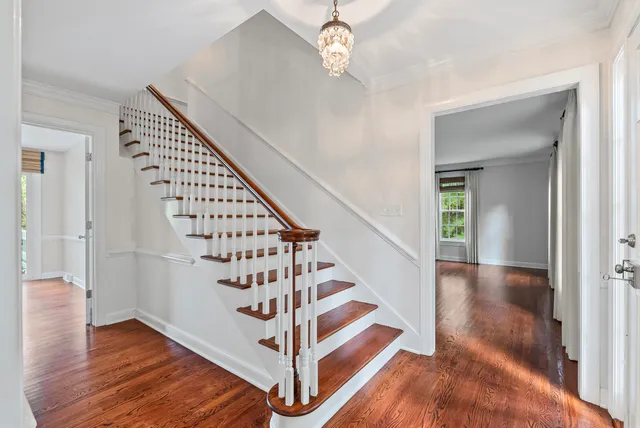 a view of entryway and hall with wooden floor