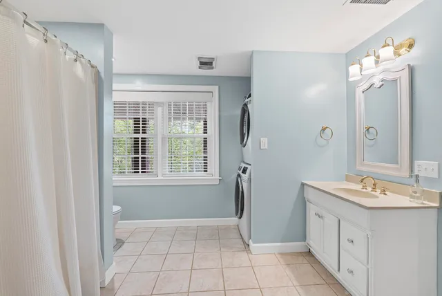 a bathroom with a double vanity sink toilet and shower