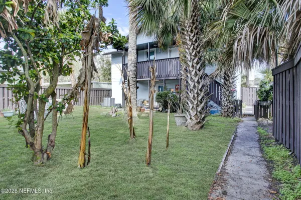 a backyard of a house with table and chairs