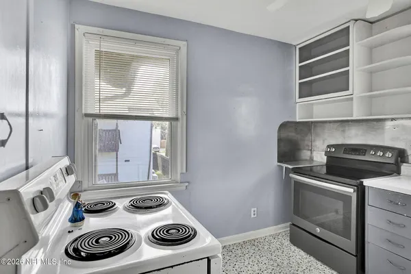 a kitchen with stainless steel appliances granite countertop a refrigerator and a stove