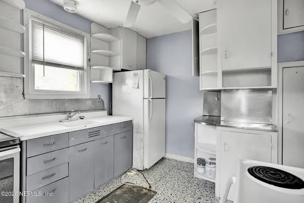 a bathroom with a sink and bathtub with toilet