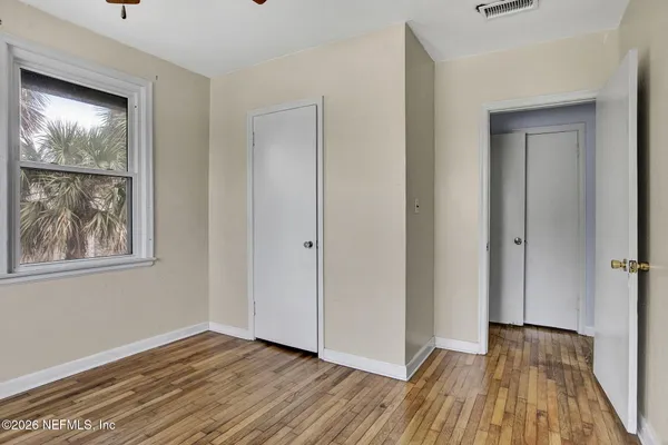 wooden floor in an empty room with a window