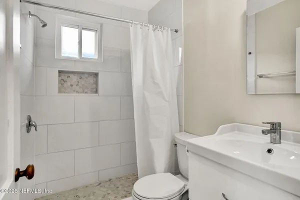 a view of a room with wooden floor and windows