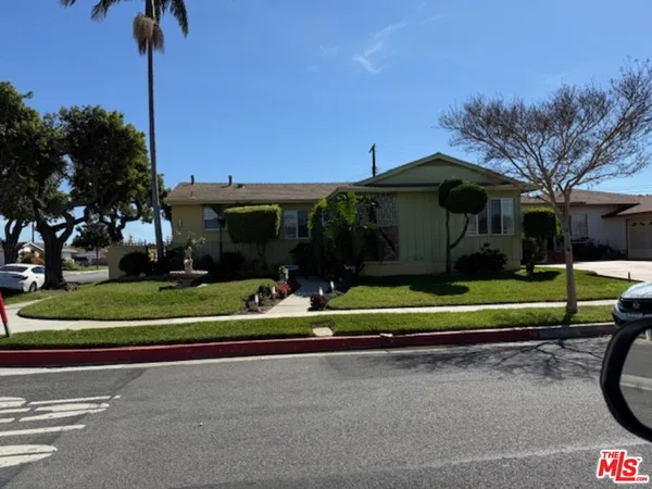 a front view of a house with a yard table and chairs
