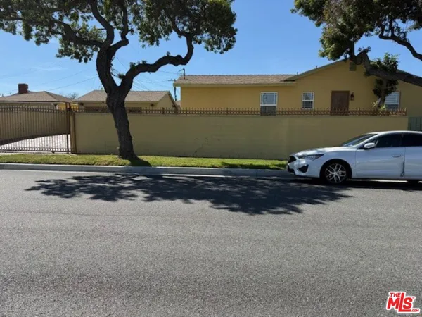a front view of a house with parking area