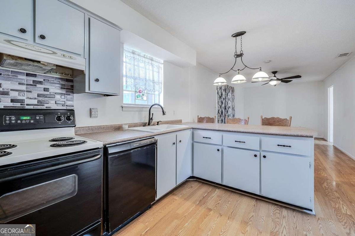 412 Rothwell Street Pooler, GA 31322 - Photo 12 of 32 a kitchen with cabinets stainless steel appliances and a counter space