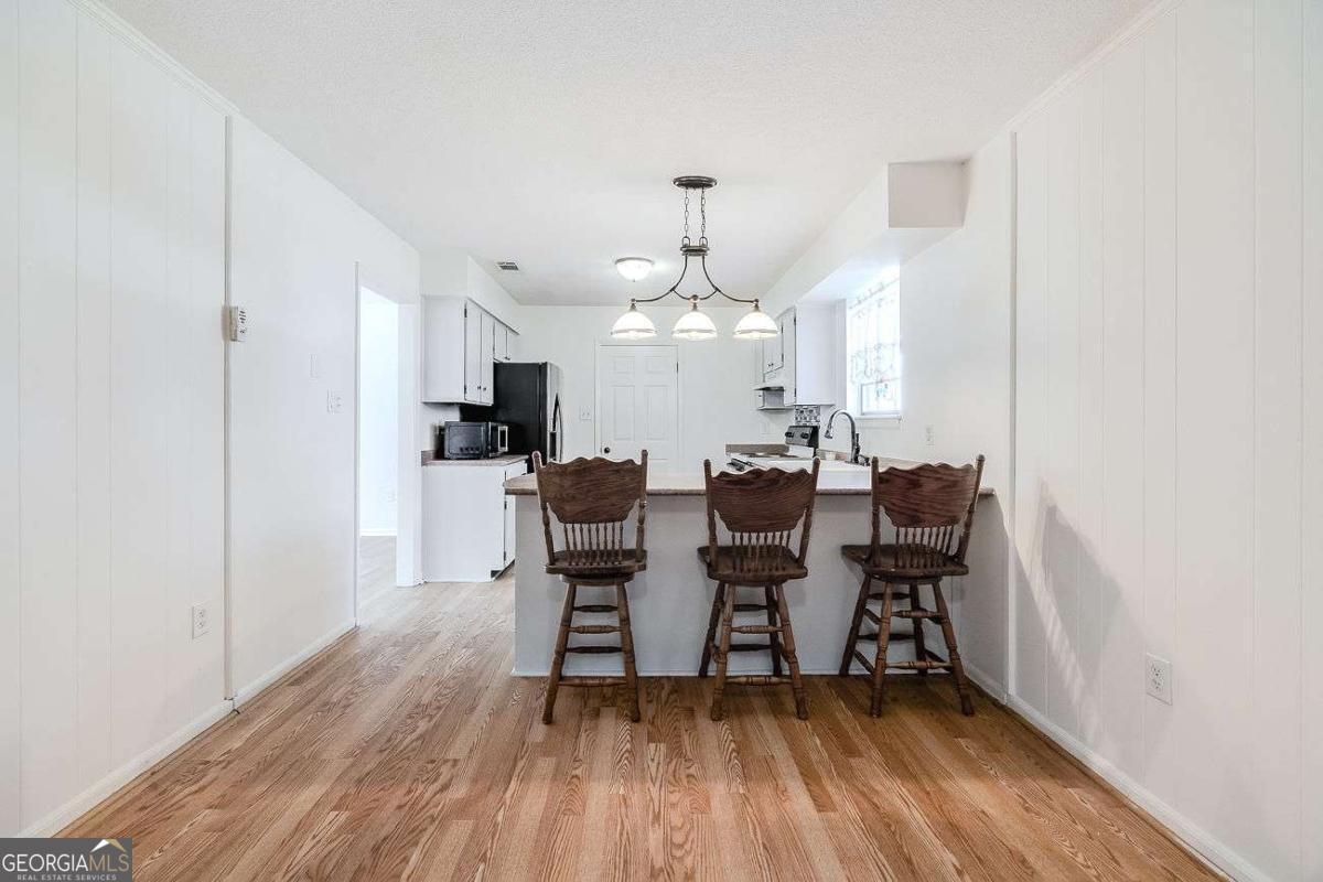 412 Rothwell Street Pooler, GA 31322 - Photo 14 of 32 a view of a dining room with furniture and wooden floor