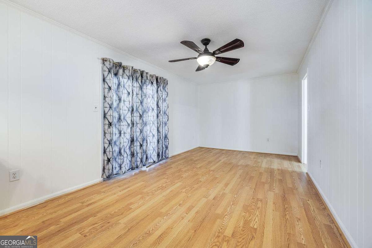 412 Rothwell Street Pooler, GA 31322 - Photo 15 of 32 a view of a big room with wooden floor and closet in a small kitchen