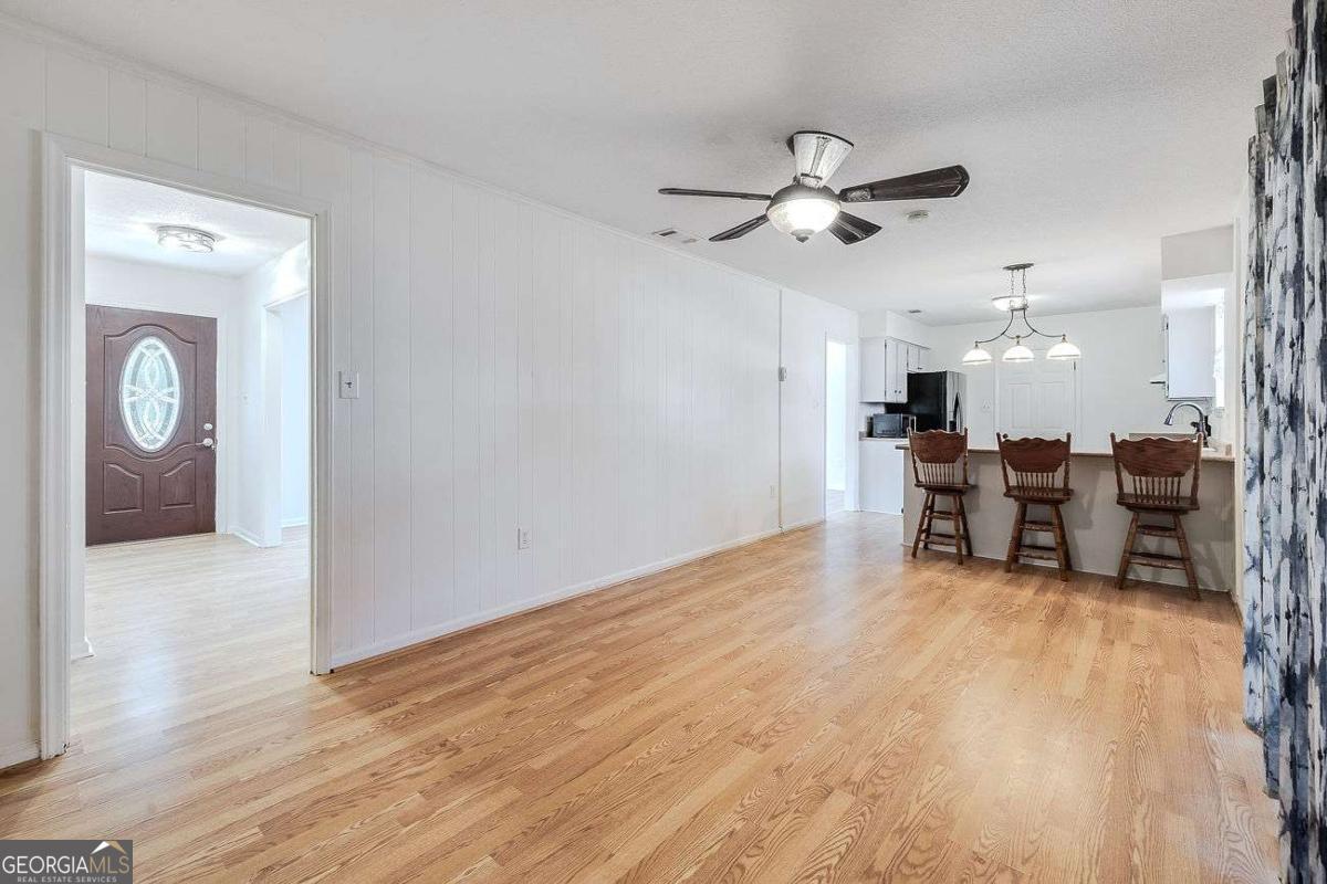 412 Rothwell Street Pooler, GA 31322 - Photo 17 of 32 a view of a livingroom with furniture a ceiling fan and wooden floor