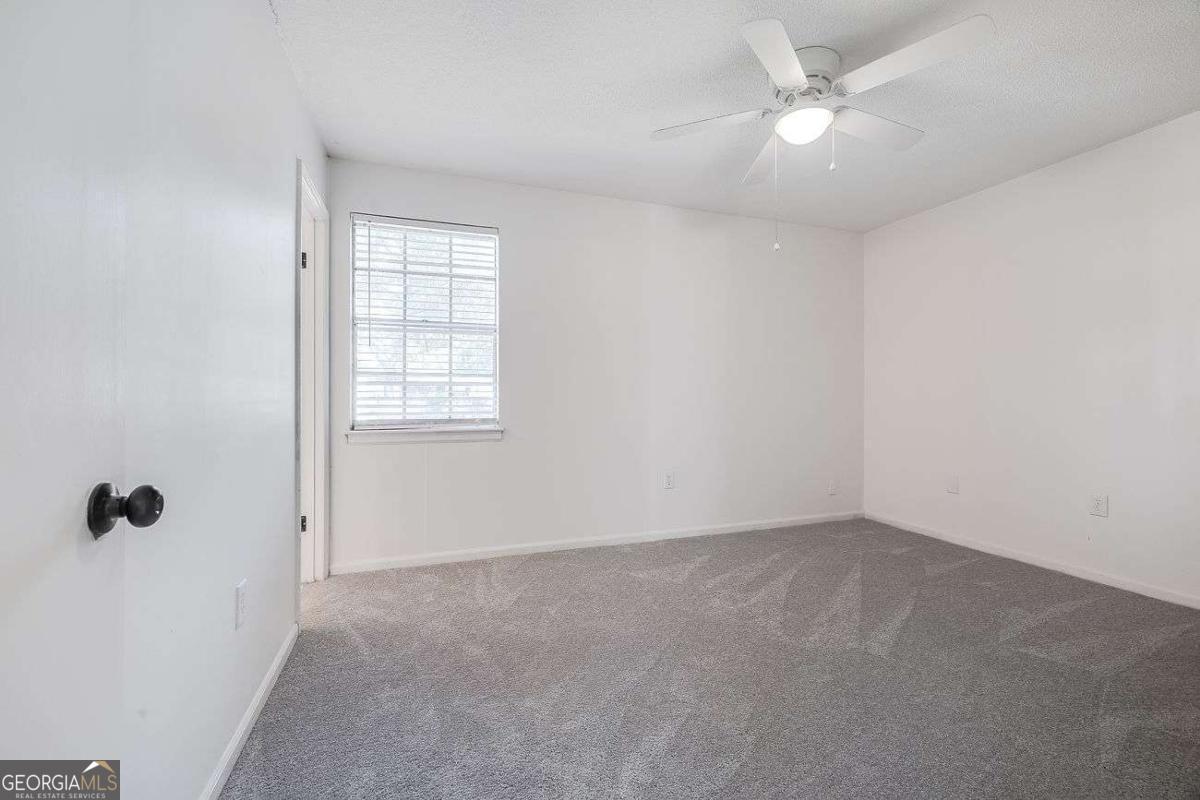 412 Rothwell Street Pooler, GA 31322 - Photo 18 of 32 an empty room with a window and a fan