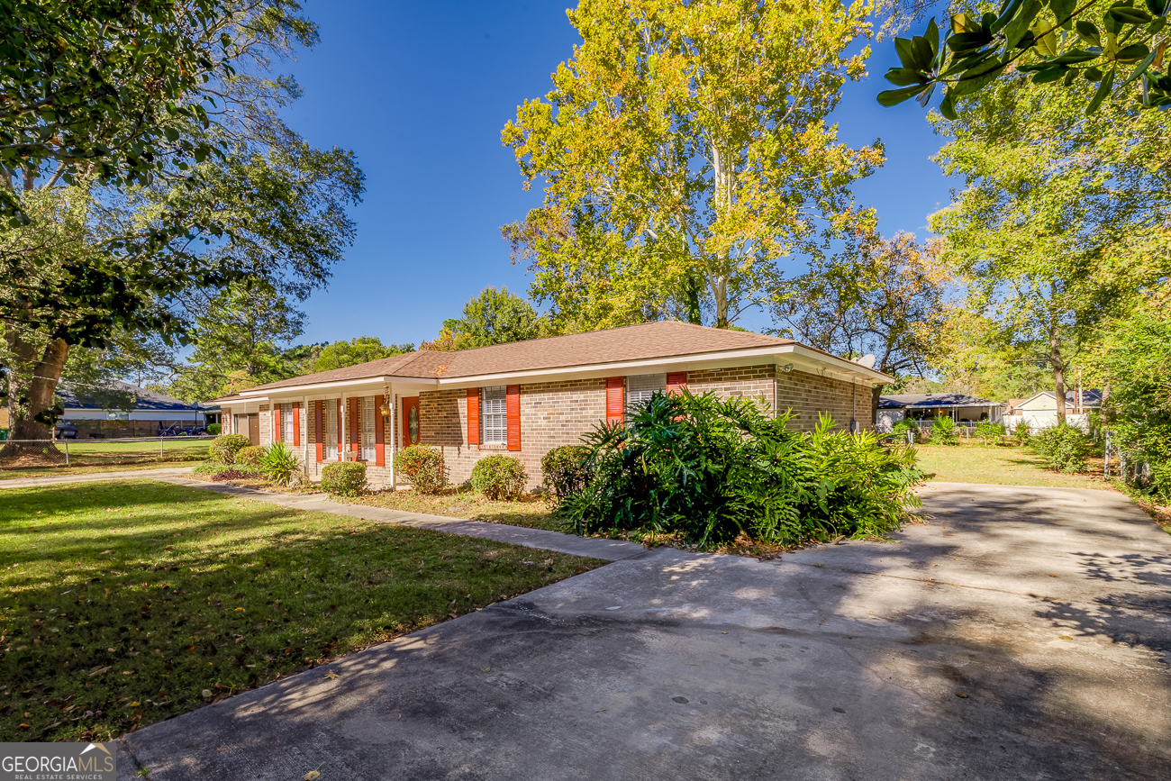 412 Rothwell Street Pooler, GA 31322 - Photo 2 of 32 a front view of a house with a yard and trees