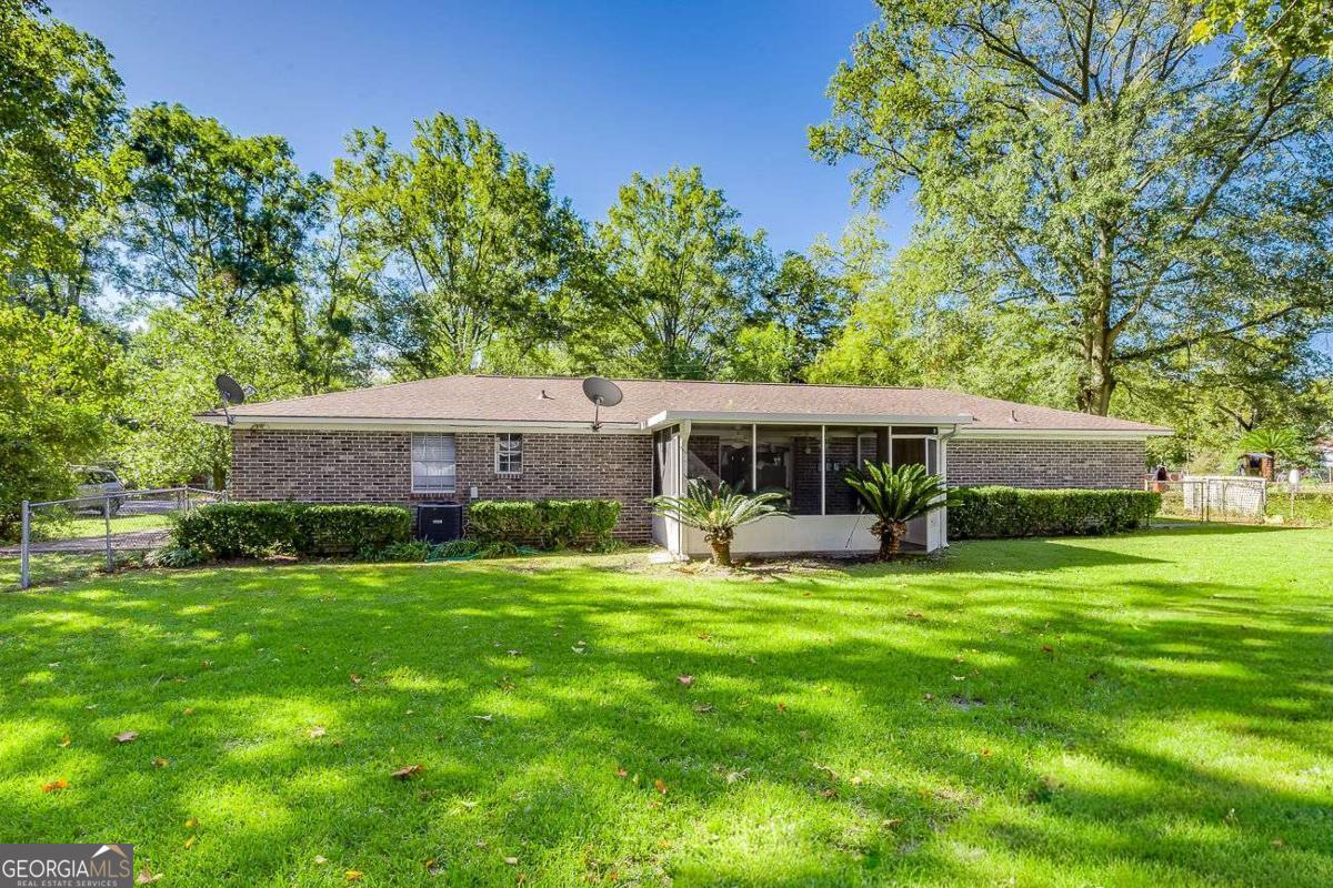412 Rothwell Street Pooler, GA 31322 - Photo 28 of 32 a view of a house with a yard potted plants and large tree