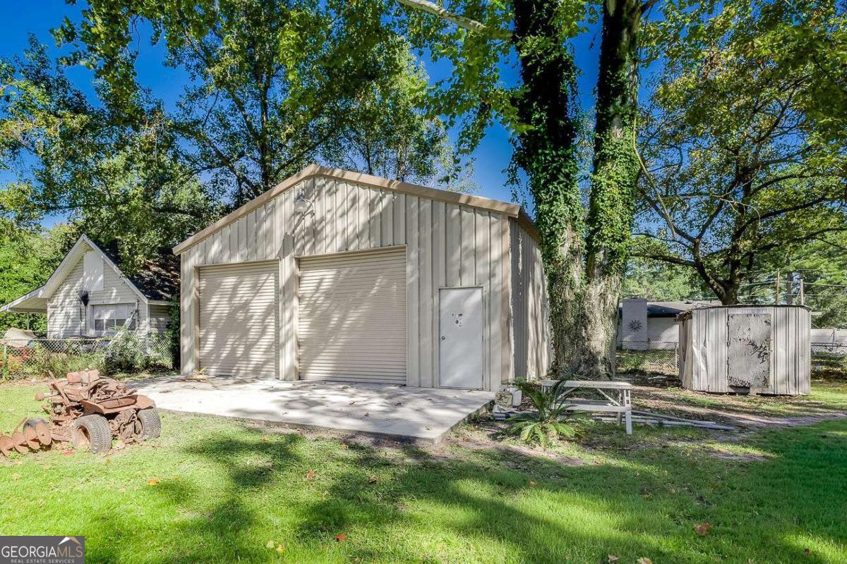 412 Rothwell Street Pooler, GA 31322 - Photo 30 of 32 a view of backyard with large tree and wooden fence