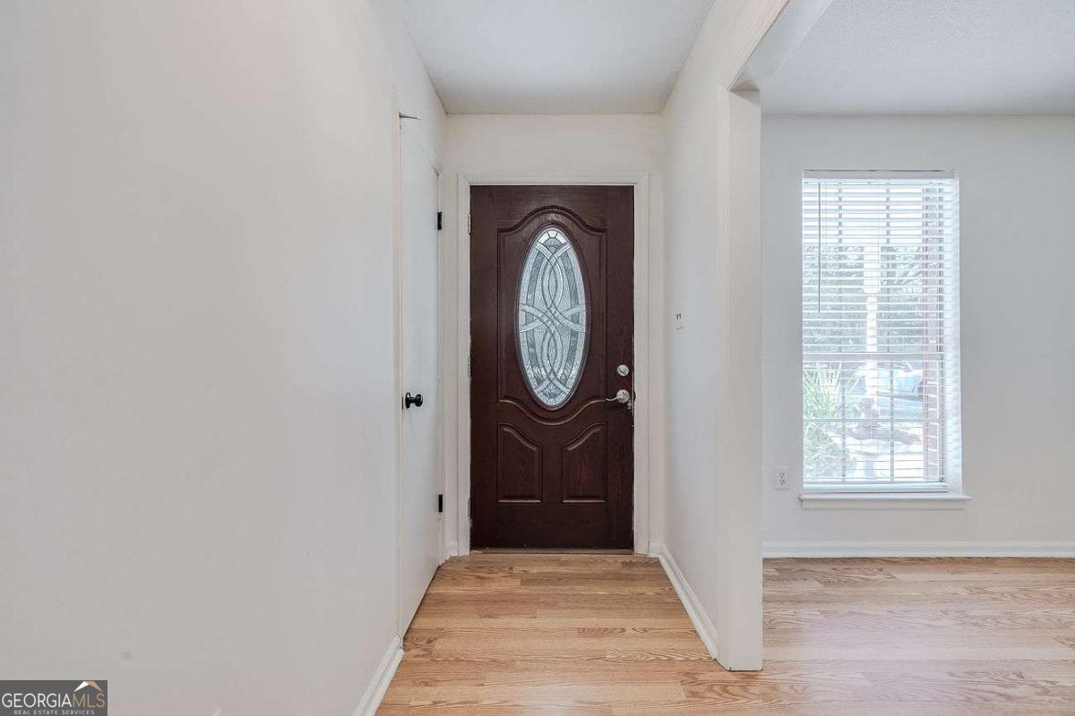 412 Rothwell Street Pooler, GA 31322 - Photo 5 of 32 an entryway with wooden floor mirror and a window