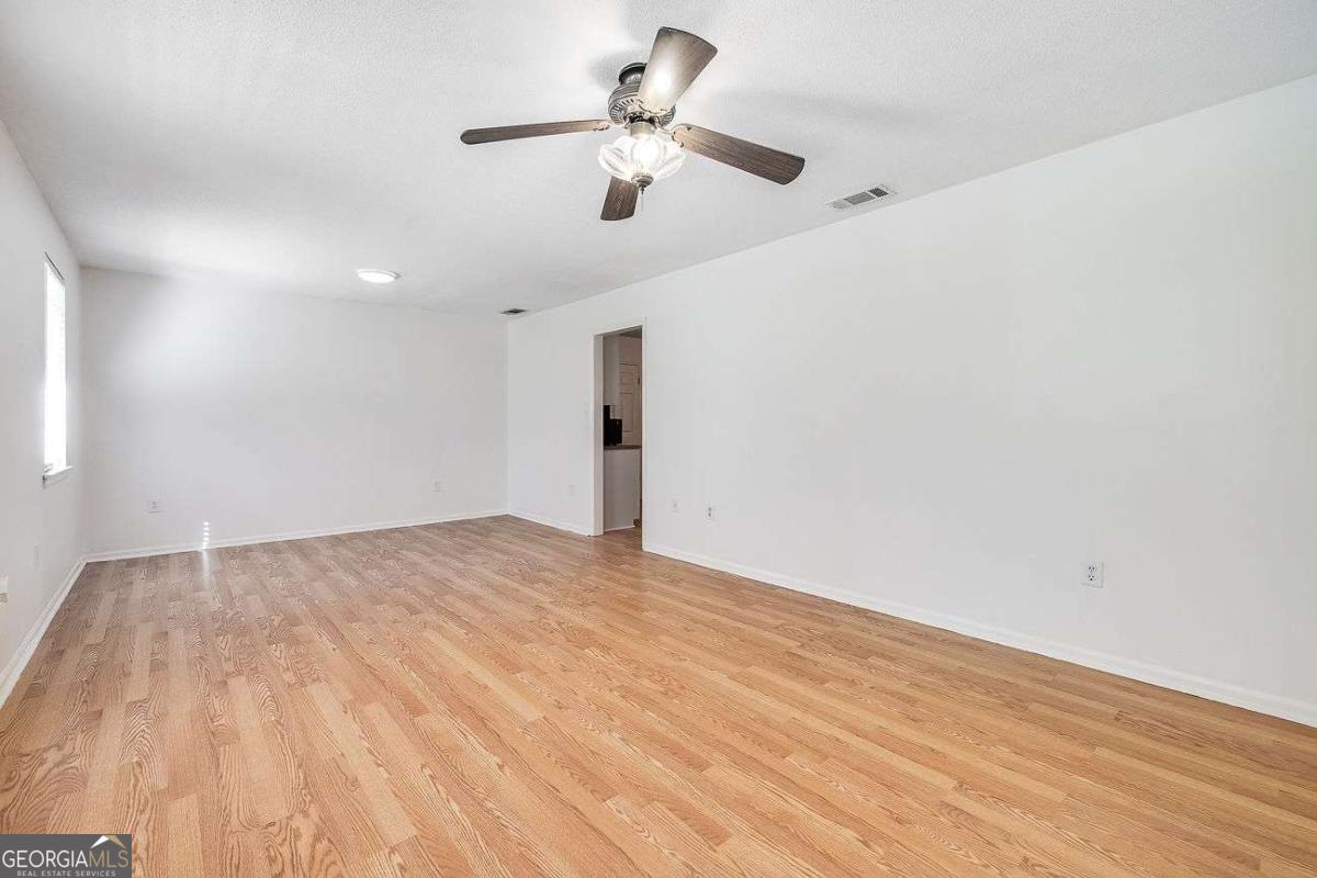 412 Rothwell Street Pooler, GA 31322 - Photo 7 of 32 a view of empty room with wooden floor