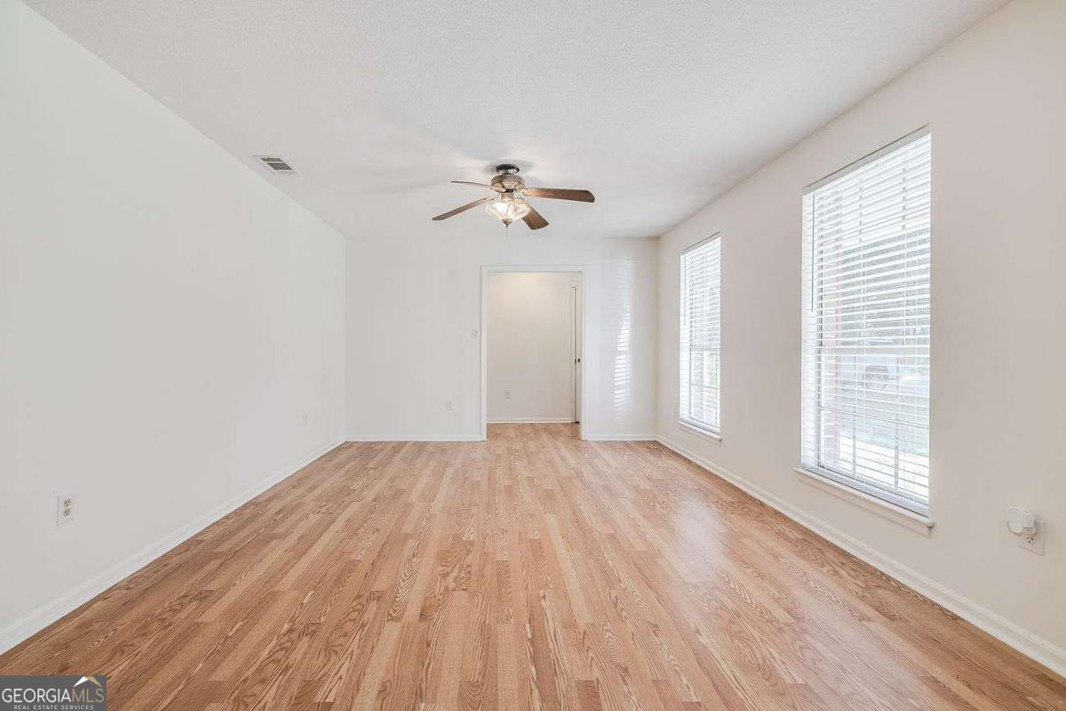 412 Rothwell Street Pooler, GA 31322 - Photo 8 of 32 wooden floor in an empty room with a window