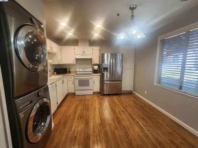 a kitchen with stainless steel appliances a stove a refrigerator sink and cabinets