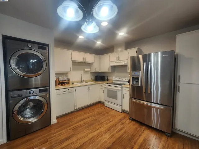 a kitchen with a refrigerator and a stove top oven