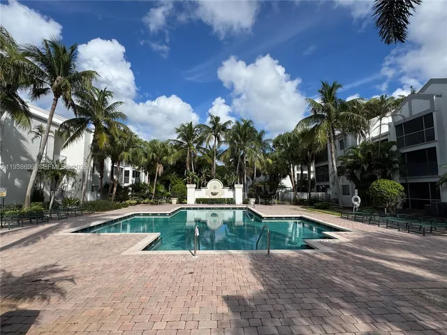 a view of a swimming pool with palm trees