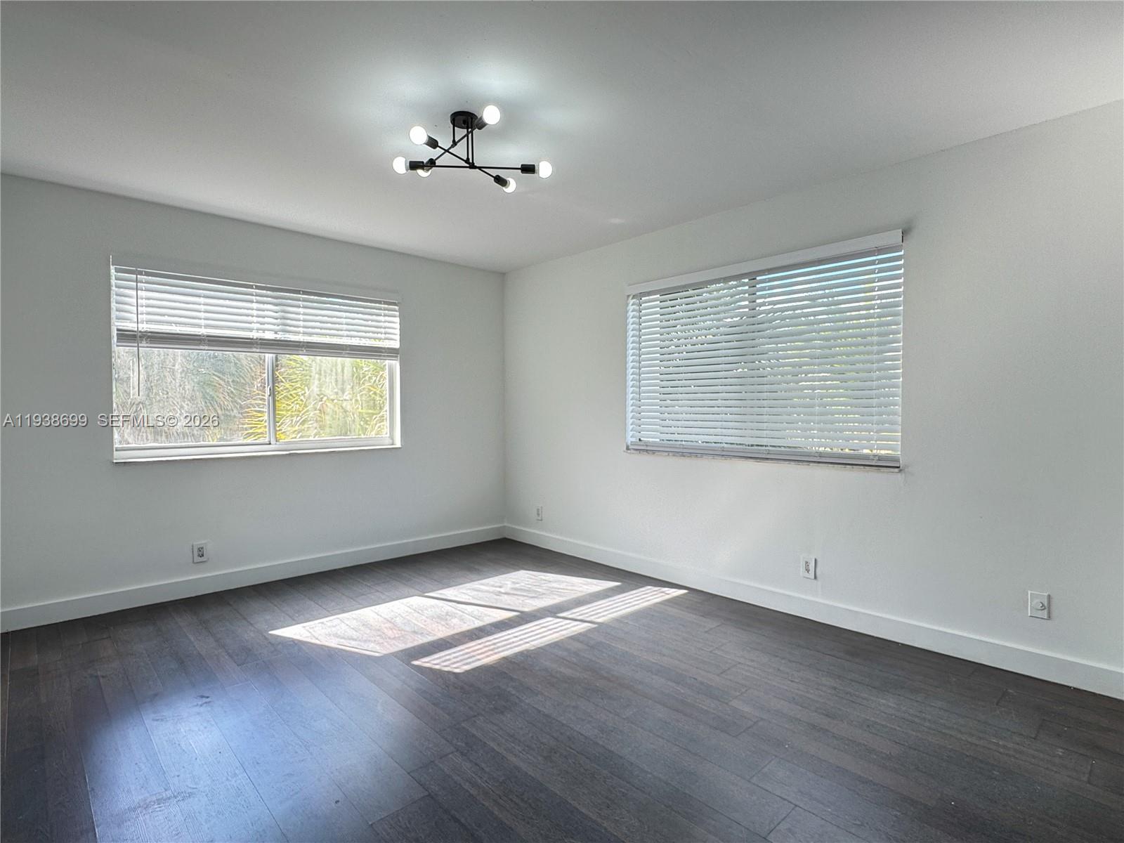5672 Rock Island Road, Unit 271 Tamarac, FL 33319 - Photo 5 of 11 a view of an empty room with wooden floor and a window