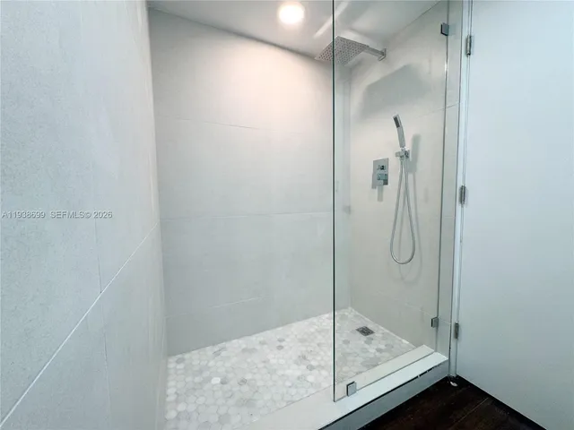 a bathroom with a glass shower door