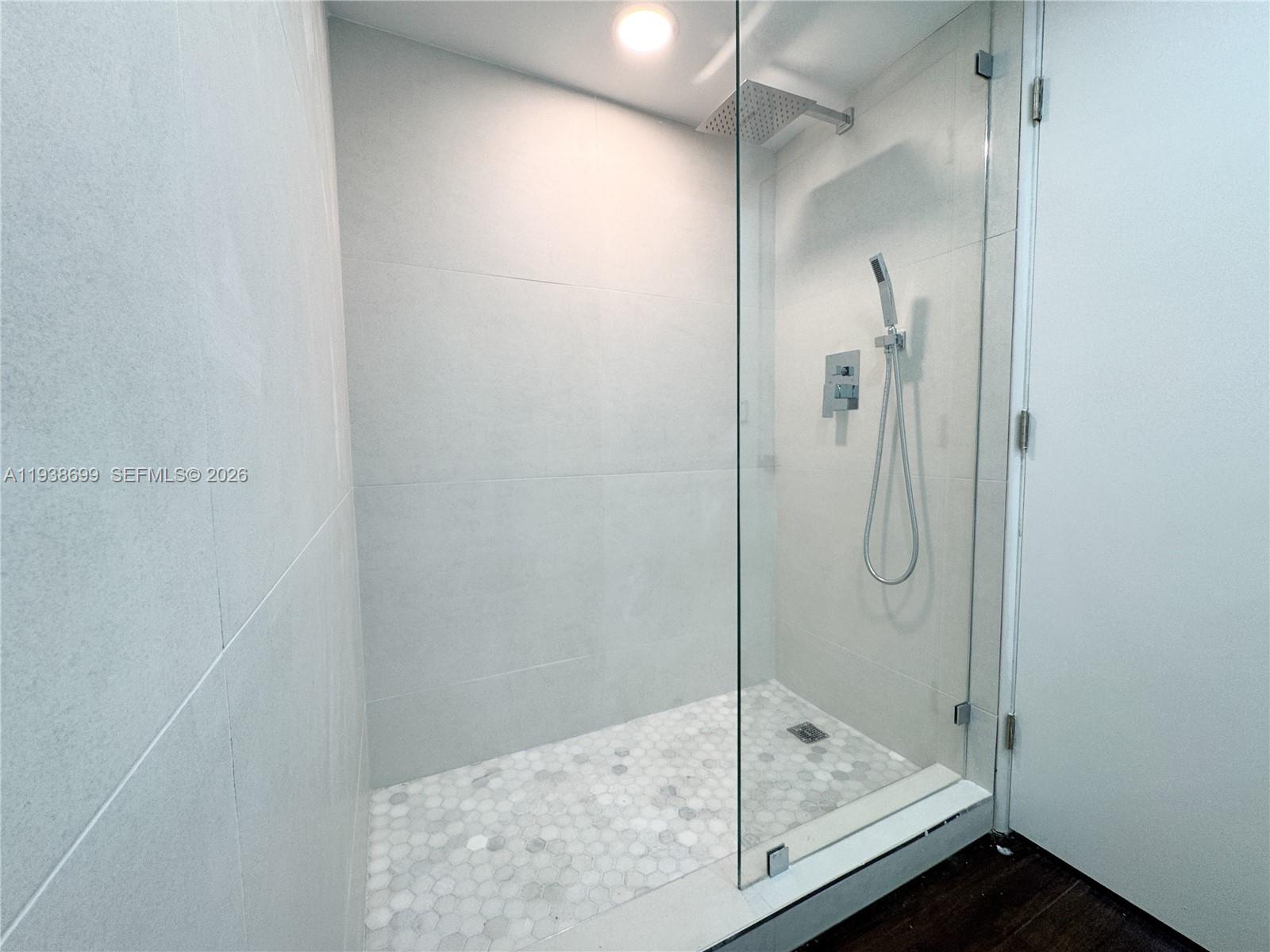 5672 Rock Island Road, Unit 271 Tamarac, FL 33319 - Photo 7 of 11 a bathroom with a glass shower door