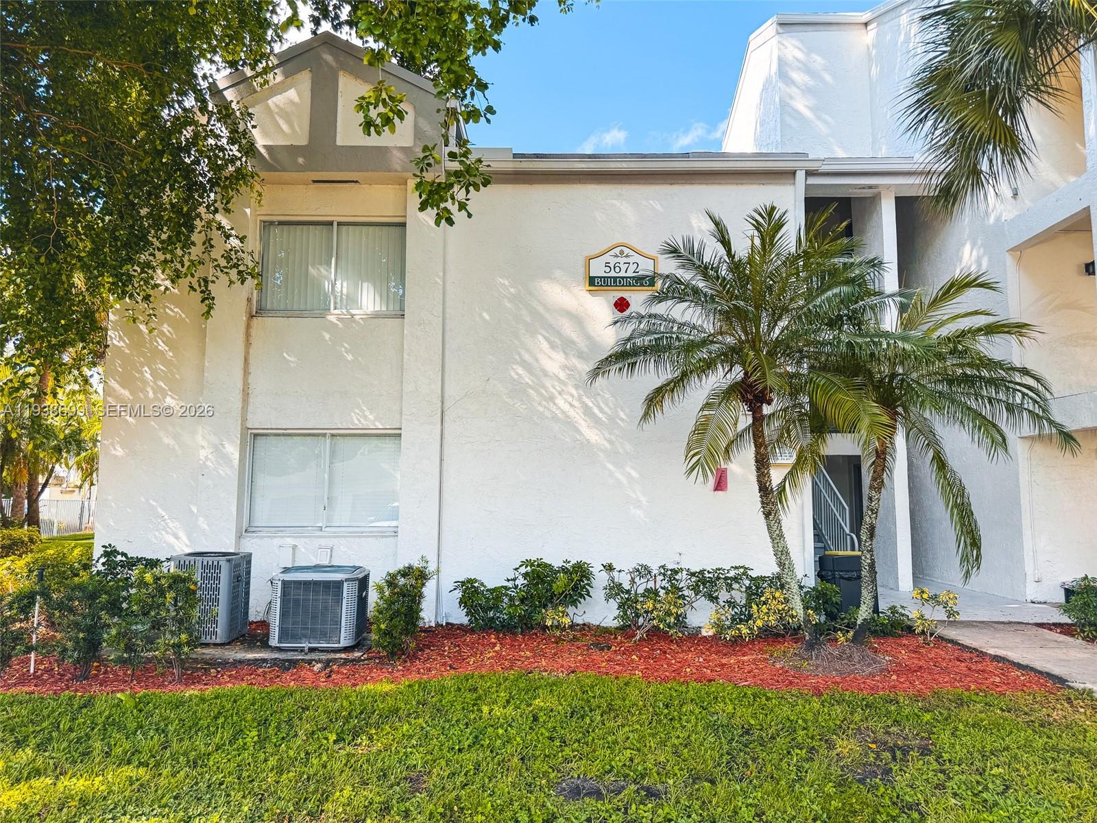 5672 Rock Island Road, Unit 271 Tamarac, FL 33319 - Photo 8 of 11 a front view of a house with garden