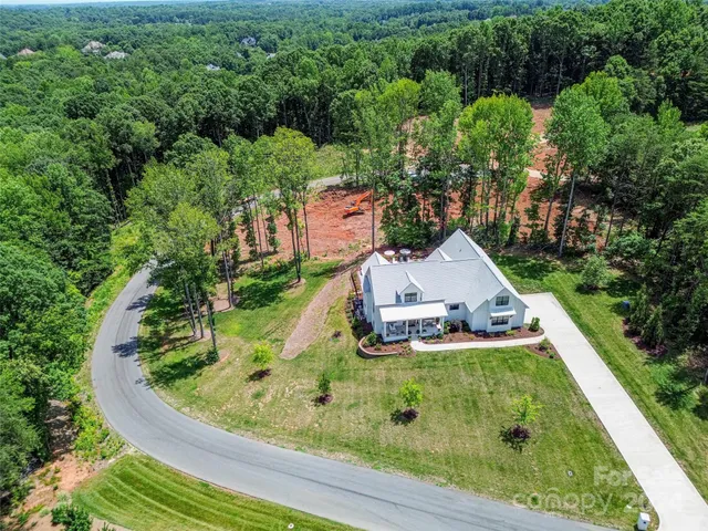 an aerial view of a house with garden space sitting space and swimming pool