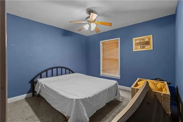 a view of a livingroom with a ceiling fan and window