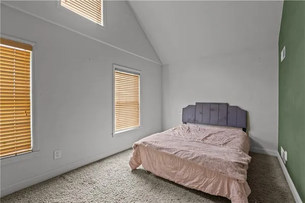 a bedroom with a bed and a table